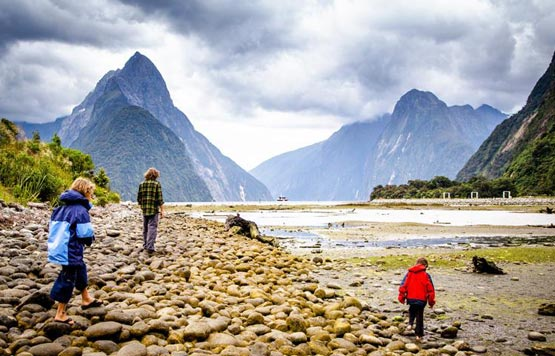 Hikers walking on rocky riverbed